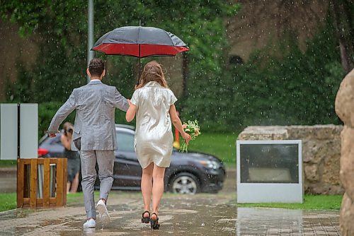 JESSE BOILY  / WINNIPEG FREE PRESS
Newly weds Mark and Nika got caught in Fridays rainstorm during their wedding photos at the St. Boniface Cathedral on Friday. The two had just gotten married at city hall an hour before the rain started. Friday, July 17, 2020.
Reporter: