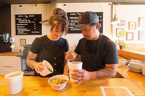 Mike Sudoma / Winnipeg Free Press
Khao House owners (left to right) Korene McCaig and Randy Khounnoraj put the finishing touches on an order of their popular cheesy noodle dish Friday afternoon
July 17, 2020