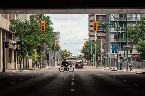 Mike Sudoma / Winnipeg Free Press
A cyclist rides across York St under the Convention Centre sky walkway Saturday afternoon
July 18, 2020