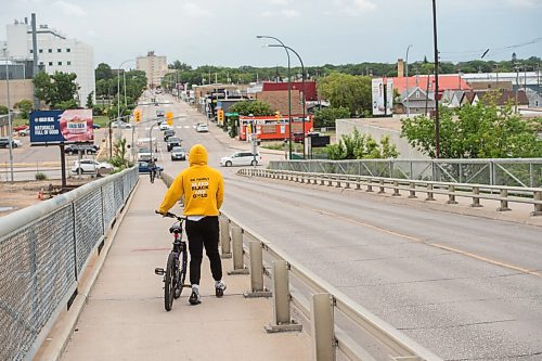 Mike Sudoma / Winnipeg Free Press
A young cyclist walks their bike down the Arlington bridge Saturday afternoon
July 18, 2020