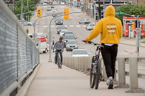 Mike Sudoma / Winnipeg Free Press
A young cyclist walks their bike down as another young cyclist works their way up the Arlington bridge Saturday afternoon
July 18, 2020