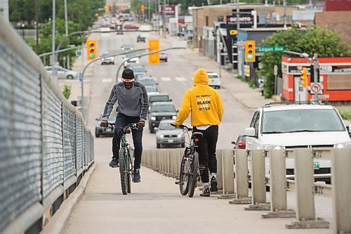 Mike Sudoma / Winnipeg Free Press
Two young cyclists pass each other on the side as they work their way up and down the Arlington bridge Saturday afternoon
July 18, 2020
