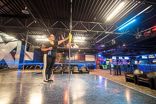 Mike Sudoma / Winnipeg Free Press
Lipstixx Eperience employee, Tracy Pottinger sanitizes a dancer pole as sanitization practises take place more frequently since the club has re-opened after the CoVid 19 quarantine.
July 18, 2020