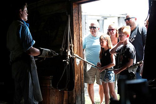 JOHN WOODS / WINNIPEG FREE PRESS
Meagan Gyde-Johnston and her husband Mike Johnston with children Nathaniel and Daphne, and her parents Debra and Bob Gyde look on as interpreter Mr Scott, the local blacksmith, tells the history of Lower Fort Garry Sunday, July 19, 2020. The park opened to visitors on Tuesday.

Reporter: desilva