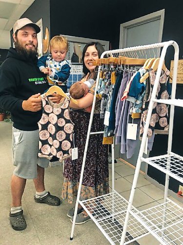 Canstar Community News Chris (left, with three-month-old Thatcher) and Torrence Ledwich (holding their two-year-old son, Hudson) show off some of the Hudson + Co clothing line at Fresh Start Thrift.