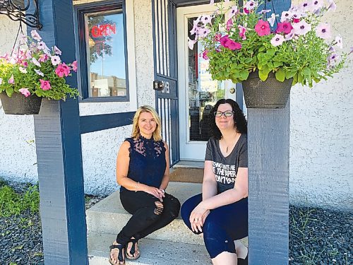 Canstar Community News The Scrapbook Cottage owner Sharon Reimer (left in all photos) and store manager Kathy Biondi pose in front of the store's new location at 1063 St. Mary's Rd.