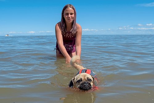 JESSE BOILY  / WINNIPEG FREE PRESS
It was Peppercorns first time at the beach as she swam with Eva Dickson, 10, at the Winnipeg Beach Dog Beach on Monday. Monday, July 20, 2020.
Reporter: