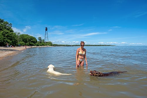 JESSE BOILY  / WINNIPEG FREE PRESS
Shauna Dripps throws a stick into the water for Duke at the Winnipeg Beach Dog Beach on Monday. Monday, July 20, 2020.
Reporter: