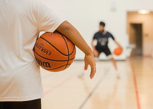 Mike Sudoma / Winnipeg Free Press
A basketball player holds a basket ball under their arm as they listen to coach, Sukvhir Singh describe a drill during the Attack Basketball Camp held at Amber Trails Community School Tuesday afternoon
July 21, 2020