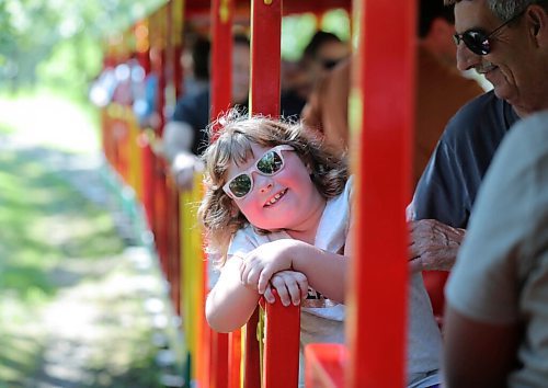 RUTH BONNEVILLE / WINNIPEG FREE PRESS

Local -  Standup Steam Train 

Hannah Cowan, who will be 7 years-old in two weeks, enjoys riding the Assiniboine Park Steam Train with her family on Wednesday afternoon,  The train is sanitized between trips and is running half capacity with empty seats between riders due to COVID restrictions.    

  
July 22nd,, 2020