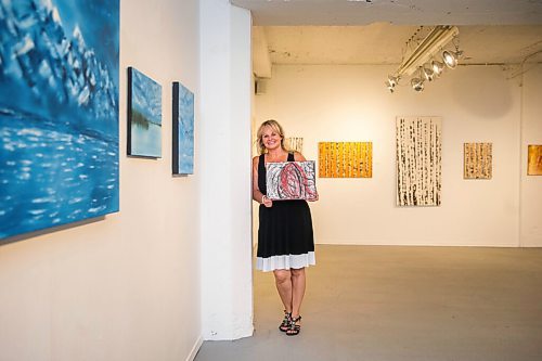 MIKAELA MACKENZIE / WINNIPEG FREE PRESS

Artist Lynley Rose holds an earlier work while in her exhibit, Come Alive and Touch the Sky, at the Cre8ery Gallery in Winnipeg on Thursday, July 23, 2020. For Frances Koncan story.
Winnipeg Free Press 2020.