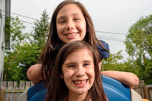 JESSE BOILY  / WINNIPEG FREE PRESS
Twins Kimber, top, and Auryla Louis play in their yard at their home on Thursday. The twins received the Sunshine Fund which allow them to go to camp. Thursday, July 23, 2020.
Reporter: Nadya