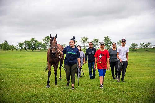 MIKAELA MACKENZIE / WINNIPEG FREE PRESS

Madison Tirk leads stakes winner Labhay with Jerry Gourneau barn team members (left-right) Jessie Sanderson, Sheldon Chickeness, Drake Peters, Jennifer Tourangeau, and Aidin Tourangeau at the Assiniboia Downs backstretch in Winnipeg on Friday, July 24, 2020. For George Williams story.
Winnipeg Free Press 2020.