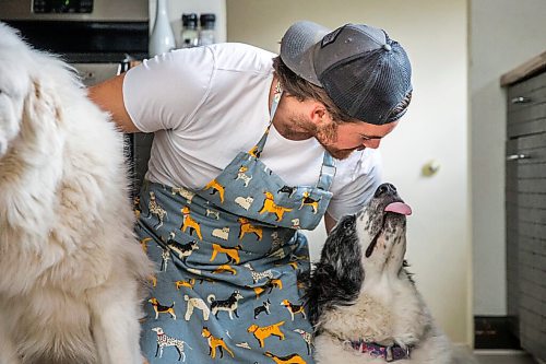 MIKAELA MACKENZIE / WINNIPEG FREE PRESS

Blue Bomber fullback John Rush, who just started a food blog called Rescue Dog Kitchen, poses for a portrait with his dogs, Bon Homme (left), and Bailey in Winnipeg on Friday, July 24, 2020. For Eva Wasney story.
Winnipeg Free Press 2020.