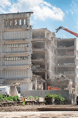 Mike Sudoma / Winnipeg Free Press
A construction worker watches as dust and debris fall to the ground as demoliton of the Public Safety building enters its sixth straight month
July 24, 2020