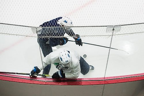 Mike Sudoma / Winnipeg Free Press
Winnipeg Jets captain, Mark Scheifele gets hit into the boards by Mathieu Perrault during practice at the Ice Plex Saturday morning
July 25, 2020