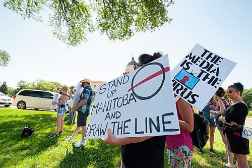 Mike Sudoma / Winnipeg Free Press
Members/Supporters of The Line, a group against the CoVid quarantine/restrictions, hold signs as they rally along Broadway St Saturday afternoon
July 24, 2020