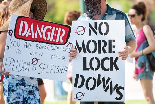 Mike Sudoma / Winnipeg Free Press
Members/Supporters of The Line, a group against the CoVid quarantine/restrictions, hold signs as they rally along Broadway St Saturday afternoon
July 24, 2020