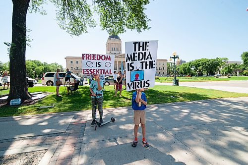 Mike Sudoma / Winnipeg Free Press
Young supporters of The Line, a group against the CoVid quarantine/restrictions, hold signs as they rally along Broadway St with their parents and other supporters Saturday afternoon
July 24, 2020