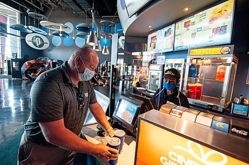 Mike Sudoma / Winnipeg Free Press
Movie goer, Sean Crawford, picks up drinks form the concession stand as he gets ready to enjoy a movie at Scotiabank Theatre for the first time since the CoVid 19 lockdown.
July 25, 2020
