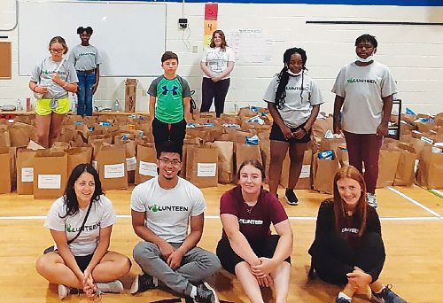 Canstar Community News Students from River East Transcona School Divisions Volunteen program take a break from packing boxes of food destined for hungry families across Winnipeg.