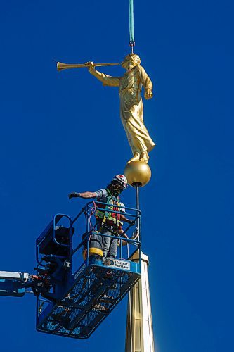 MIKE DEAL / WINNIPEG FREE PRESS
Construction workers raise a large, gold-leafed statue on to the steeple of The Church of Jesus Christ of Latter-day Saints first temple in Manitoba early Tuesday morning in Winnipegs Bridgwater neighbourhood. 
The iconic symbol of The Church of Jesus Christ of Latter-day Saints stands high on top of most of its 168 temples worldwide. The statue depicts Moroni, an ancient prophet in the Book of Mormon, a book of scripture that is used side by side with the Bible by members of the Church. The gold-leafed statue depicts Moroni blowing a trumpet, which symbolizes the spreading of the restored gospel of Jesus Christ.  
See John Longhurst story
200728 - Tuesday, July 28, 2020.