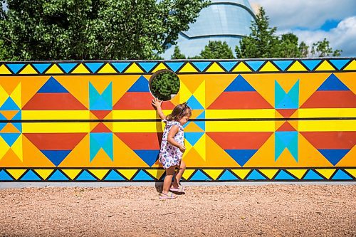 MIKAELA MACKENZIE / WINNIPEG FREE PRESS
Penny Sinclair-Peters-Tucker (two) walks past a new mural, Wokpan Shina, by artist Kristin Flattery at The Forks in Winnipeg on Tuesday, July 28, 2020. The design is inspired by traditional beading, where the stitches represent diversity and resilience. Standup.
Winnipeg Free Press 2020.