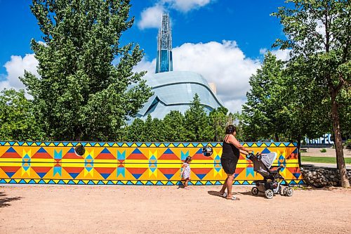 MIKAELA MACKENZIE / WINNIPEG FREE PRESS

Sue Tucker and her granddaughter, Penny Sinclair-Peters-Tucker (two), walk past a new mural, Wokpan Shina, by artist Kristin Flattery at The Forks in Winnipeg on Tuesday, July 28, 2020. The design is inspired by traditional beading, where the stitches represent diversity and resilience. Standup.
Winnipeg Free Press 2020.