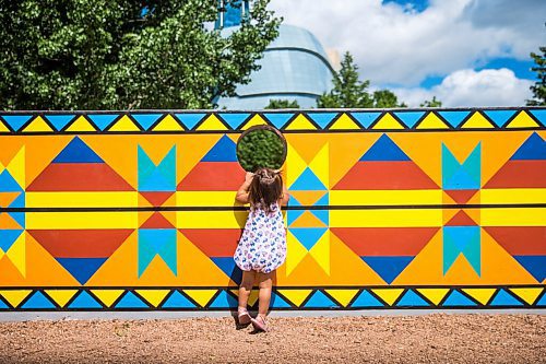 MIKAELA MACKENZIE / WINNIPEG FREE PRESS

Penny Sinclair-Peters-Tucker (two) walks past a new mural, Wokpan Shina, by artist Kristin Flattery at The Forks in Winnipeg on Tuesday, July 28, 2020. The design is inspired by traditional beading, where the stitches represent diversity and resilience. Standup.
Winnipeg Free Press 2020.