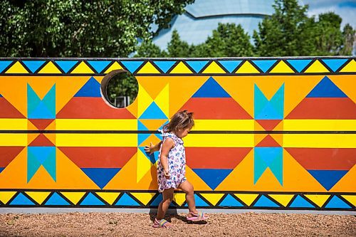 MIKAELA MACKENZIE / WINNIPEG FREE PRESS

Penny Sinclair-Peters-Tucker (two) walks past a new mural, Wokpan Shina, by artist Kristin Flattery at The Forks in Winnipeg on Tuesday, July 28, 2020. The design is inspired by traditional beading, where the stitches represent diversity and resilience. Standup.
Winnipeg Free Press 2020.