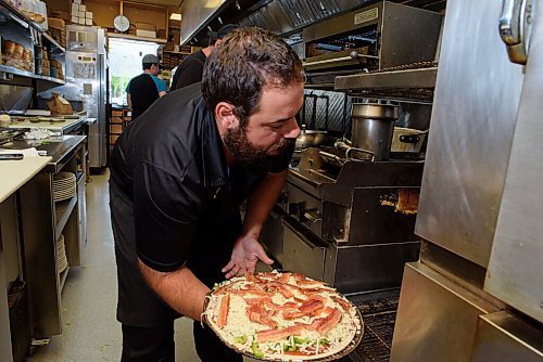 JESSE BOILY  / WINNIPEG FREE PRESS
Giorgo Kodalonis, whos worked in the family business since he was 13, puts a pizza into the oven at Dals Restaurant and Lounge in Transcona on Wednesday. Wednesday, July 29, 2020.
Reporter: Allison