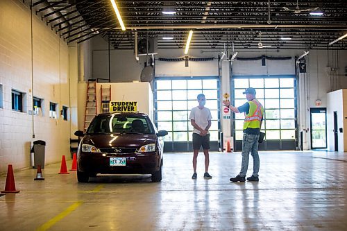 MIKAELA MACKENZIE / WINNIPEG FREE PRESS

Examiner Yuri Yermilov (right) preps Diego Gilon before taking him on a driving test in Winnipeg on Wednesday, July 29, 2020. For Danielle Da Silva story.
Winnipeg Free Press 2020.