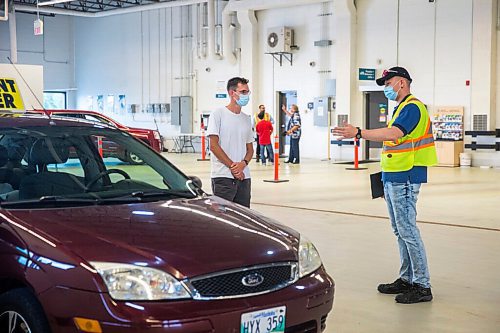 MIKAELA MACKENZIE / WINNIPEG FREE PRESS

Examiner Yuri Yermilov preps Diego Gilon before taking him on a driving test in Winnipeg on Wednesday, July 29, 2020. For Danielle Da Silva story.
Winnipeg Free Press 2020.