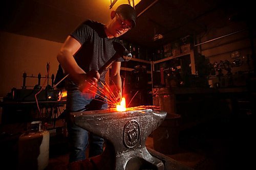 JOHN WOODS / WINNIPEG FREE PRESS
Graeson Fehr, founder of Fehr Forgeworks, is photographed at his home garage blacksmith shop in West St Paul, Wednesday, July 29, 2020. Fehr taught himself how to blacksmith at 14. Fehr is internationally recognized and ships his knives all over the world.

Reporter: Sanderson