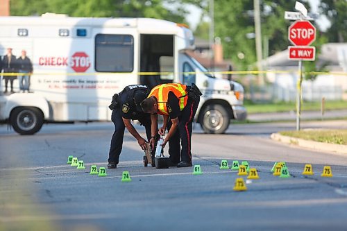 MIKE DEAL / WINNIPEG FREE PRESS

Winnipeg Police forensics unit are at the scene of an accident on Grey Street between Munroe and Moncton Avenues. That stretch or Grey Street is closed with dozens of evidence markers on the road. A helmet and a bicycle could be seen amongst the evidence markers. 
200730 - Wednesday, July 30, 2020.