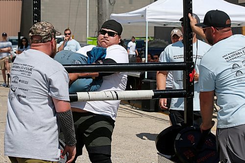 JOHN WOODS / WINNIPEG FREE PRESS
Brendon Wood tosses a 175lb sandbag over the rail in the Loading Race at the third annual Manitoba Classic Strongman Competition at Brickhouse Gym in Winnipeg Sunday, August 2, 2020. Competitors competed in the Yoke - Farmers Medley, Log Clean and Press, Loading Race, Axle Deadlift and the Tire Flip. Proceeds were donated to Little Warriors childrens charity.

Reporter: Standup