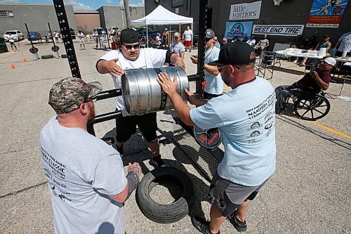 JOHN WOODS / WINNIPEG FREE PRESS
Brendon Wood tosses a 175lb keg over the rail in the Loading Race at the third annual Manitoba Classic Strongman Competition at Brickhouse Gym in Winnipeg Sunday, August 2, 2020. Competitors competed in the Yoke - Farmers Medley, Log Clean and Press, Loading Race, Axle Deadlift and the Tire Flip. Proceeds were donated to Little Warriors childrens charity.

Reporter: Standup