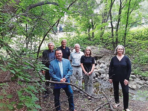 Canstar Community News Red River North MLA Jeff Wharton (front left) poses by a pair of culverts on Burr Oak Bay in the RM of East St. Paul along with Mayor Shelley Hart (front right) and councillors from the RM of East St. Paul.