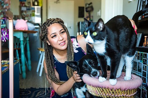 MIKAELA MACKENZIE / WINNIPEG FREE PRESS

Joanne Roberts, winner of the 2020 Gimli Film Fest Pitch Contest, poses for a portrait with her pets (dog Domino and cat Percy) at her apartment in Winnipeg on Wednesday, Aug. 5, 2020. Enjoying her home and animals are two of the five things getting her through this pandemic. For Frances Koncan story.
Winnipeg Free Press 2020.