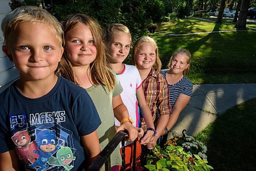 JESSE BOILY  / WINNIPEG FREE PRESS
(Front to back) Hezekiah, Susan, Aoife, Mabelle, and Sarah-Joy McQuade, 16, have all previously received the Sunshine fund stop for a photo outside her home on Wednesday. This year Sarah-Joy received the fund to help get her to camp. Wednesday, Aug. 5, 2020.
Reporter: Kellen