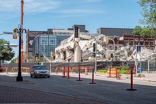 Mike Sudoma / Winnipeg Free Press
A car drives past the former Public Safety Building which has now become a pile of concrete after demolition of most of the exterior of the building and structure came to a close Friday afternoon
August 7, 2020