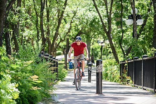 Mike Sudoma / Winnipeg Free Press
A cyclist rides across a bridge as they cycle through Stephen Juba Park Saturday afternoon
August 7, 2020