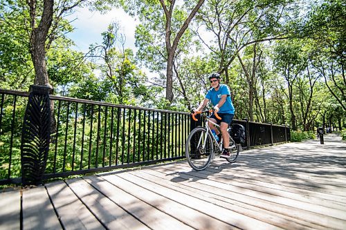 Mike Sudoma / Winnipeg Free Press
A cyclist rides across a bridge as they cycle through Stephen Juba Park Saturday afternoon
August 7, 2020