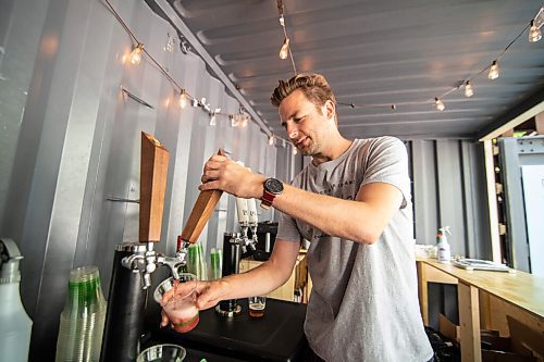 Mike Sudoma / Winnipeg Free Press
Bartender, Travis Sexsmith, pours a beer for a customer at the newly opened Bijou Patio Saturday afternoon
August 7, 2020