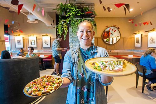 MIKAELA MACKENZIE / WINNIPEG FREE PRESS

Dana Cherski, who owns Juneberry along with three others, poses for a portrait with baby fried potatoes (left) and Honduran balaedas in the new breakfast/lunch spot in Winnipeg on Monday, Aug. 10, 2020. The restaurant has been hopping since opening in July -- no small feat amid a pandemic. For Jen Zoratti story.
Winnipeg Free Press 2020.