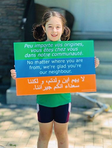 Canstar Community News Elodie Robert has been selling these signs as a fundraiser for the Immigrant and Refugee Community Organization of Manitoba.