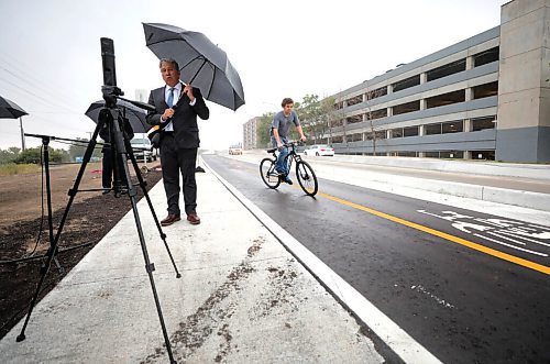 RUTH BONNEVILLE / WINNIPEG FREE PRESS

Local  - re-opening of Empress St.

Multi-use pathway on Empress Street East, just north of the newly rehabilitated overpass.

A cyclist makes his way across the bike path as Dan Vandal, Minister of Northern Affairs, speaks at the opening of the Multi-use pathway on Empress Street East, just north of the newly rehabilitated overpass, during rainstorm onThursday.  

Rochelle Squires, Minister of Municipal Relations, Province of Manitoba and Councillor Matt Allard, Chairperson of the Standing Policy Committee on Infrastructure Renewal and Public Works, also spoke at the newser Thursday. 

 Aug 13th, 2020