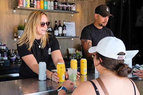 Daniel Crump / Winnipeg Free Press. Bartender Amanda Borsboom (left) serves drinks at Cargo Bar in Assiniboine Park. August 15, 2020.