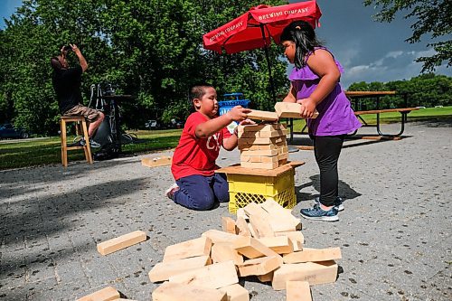 Daniel Crump / Winnipeg Free Press. Deejay Jerrybelle, 8, and his sister Jessica, 5, play a game of jenga at Cargo Bar in Assiniboine Park. August 15, 2020.