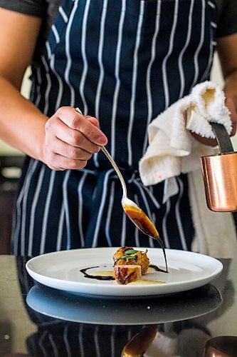 MIKAELA MACKENZIE / WINNIPEG FREE PRESS

Joshua Zacharias, one of the chefs behind Stefan (a high-end supper club run out of his downtown apartment), plates quail two ways in Winnipeg on Monday, Aug. 17, 2020. For Eva Wasney story.
Winnipeg Free Press 2020.